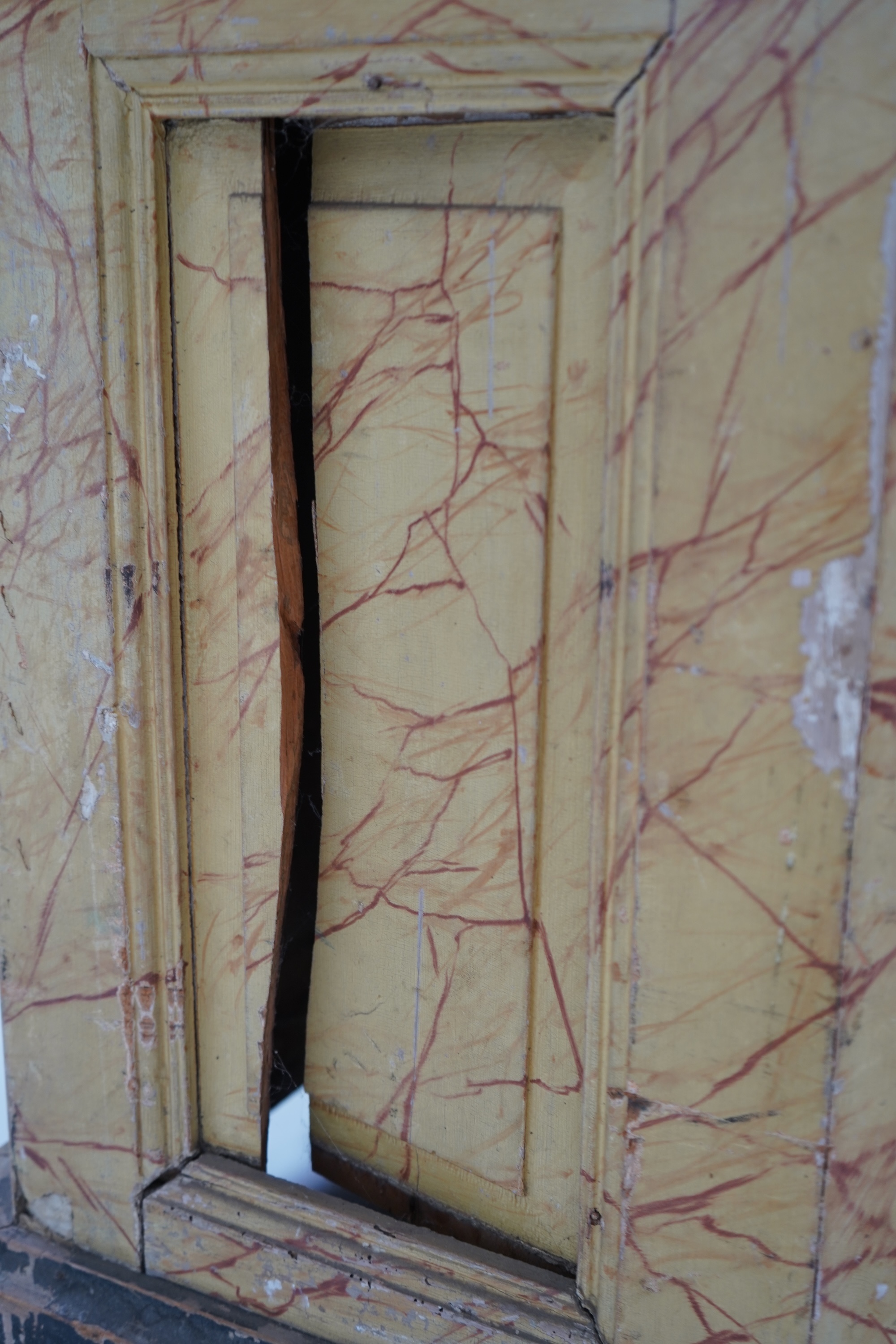 A Victorian white painted cast iron urn and a painted faux marble pedestal